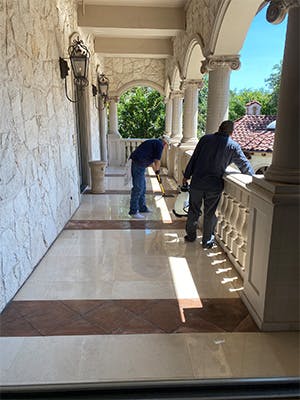 workers cleaning porch