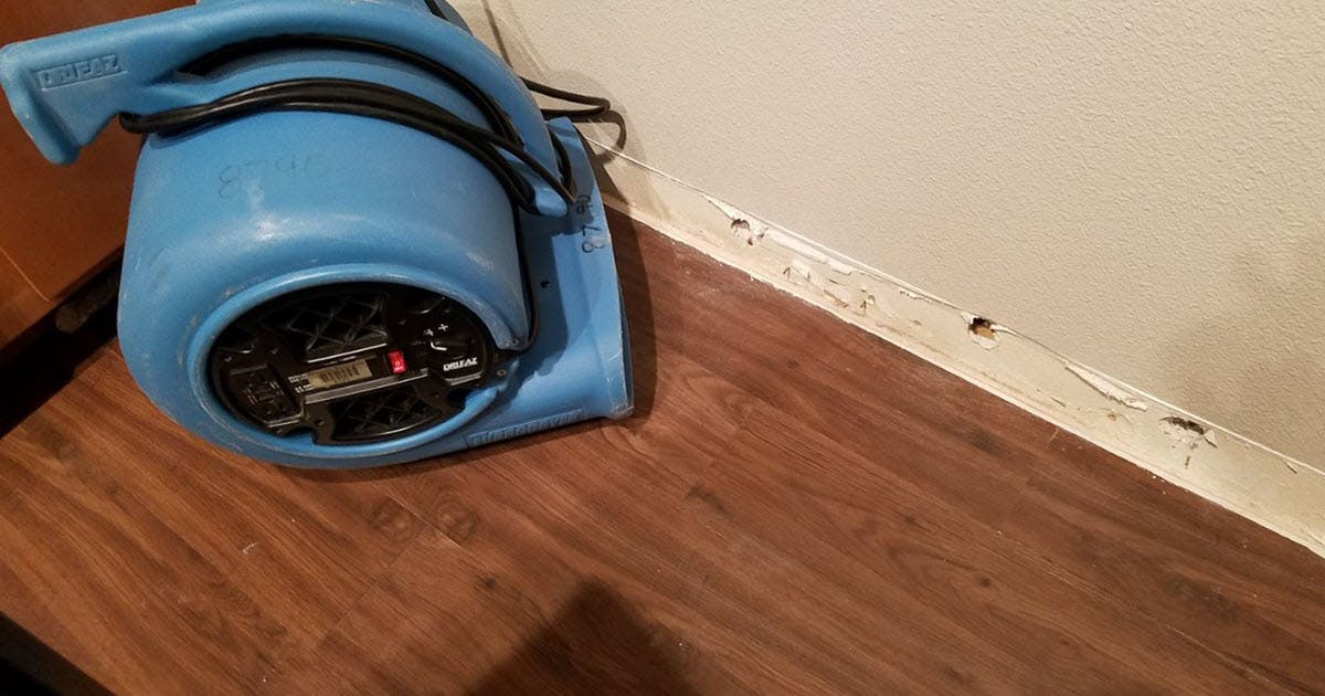 water damage on floor, humidifier blowing air on baseboard