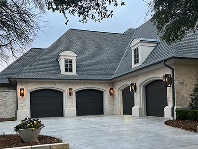 house with four car garage with dormers on the roof