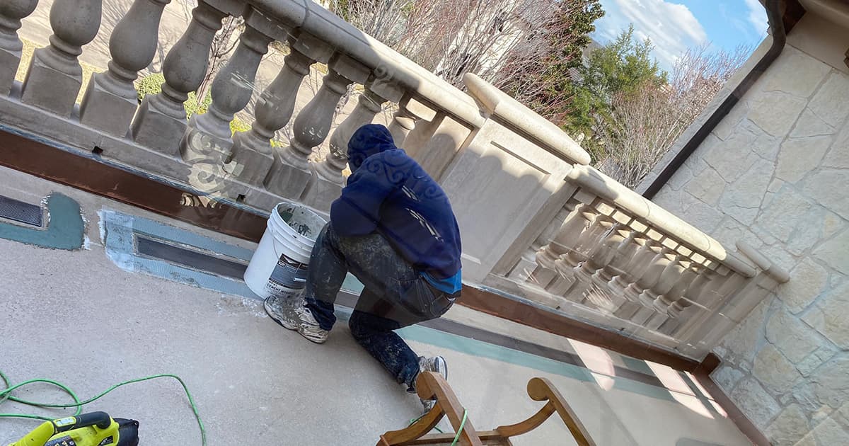 worker putting concrete on patio